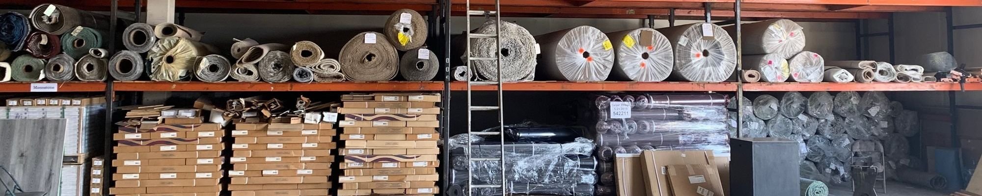 carpet rolls in warehouse on shelving from Carpet Village Warehouse/FloorscapesUSA in Los Angeles